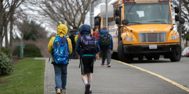 Students leave the Thurgood Marshall Elementary School after the Seattle Public School system was abruptly closed due to coronavirus fears on March 11, 2020, in Seattle.