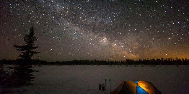 Tent camping under a rising Milky Way in Voyegeur's National Park in Minnesota.