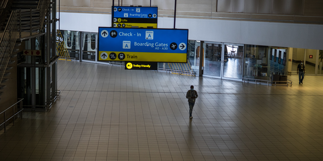 A man walks through a deserted part of Johannesburg's OR Tambo airport in South Africa on Monday.