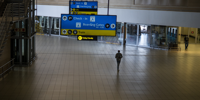 A man walks through a deserted part of Johannesburg's OR Tambo airport in South Africa on Monday.