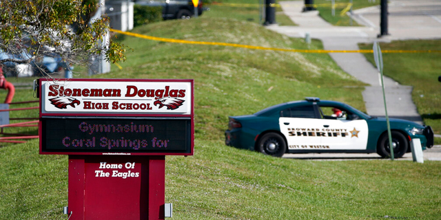 File: Law enforcement officials block access to Marjorie Stoneman Douglas High School in Parkland, Fla., After fatal shootings at school.