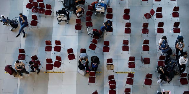 Travelers wait for documents checking, at the arrival terminal of Soekarno Hatta International airport, as the country bans the arrival of travellers who have been in eight African countries to curb the spread of the new omicron variant of the coronavirus, in Tangerang, near Jakarta, Indonesia, November 29, 2021.