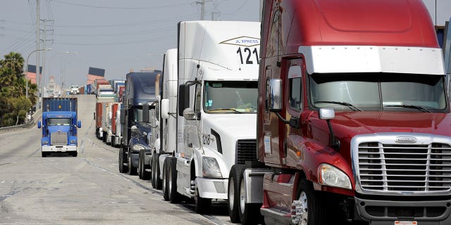 Semi-trucks line up near Pier J to retrieve shipping containers from China-based ship at the Port of Long Beach, in Long Beach, California, U.S., April 4, 2018. REUTERS/Bob Riha Jr.
