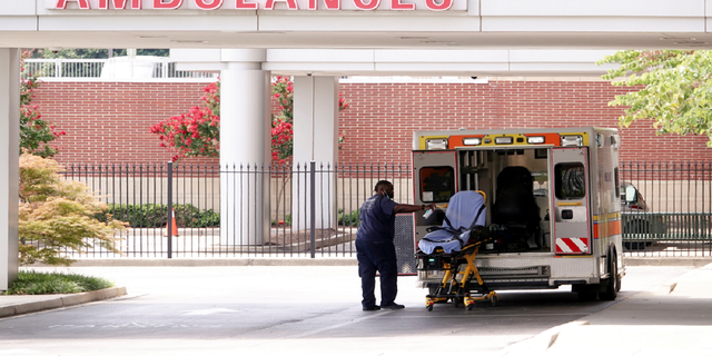 An ambulance driver disinfects a stretcher after unloading a patient on Aug. 13 at a Memphis children's hospital, after Memphis Fire Chief Gina Sweat said that emergency services were overwhelmed by numbers of coronavirus disease patients and that wait times should be expected. 