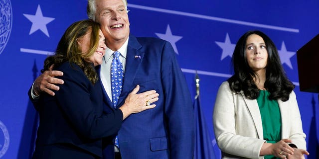 Democratic gubernatorial candidate Terry McAuliffe, right, hugs his wife, Dorothy, as he makes an appearance at an election night party in McLean, Va., Tuesday, Nov. 2, 2021. Voters are deciding between Democrat Terry McAuliffe and Republican Glenn Youngkin. (AP Photo/Steve Helber)