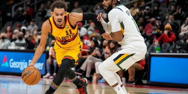Atlanta Hawks guard Trae Young (11) works to get past Utah Jazz guard Mike Conley (11) during the first half Nov. 4, 2021, at State Farm Arena in Atlanta, Georgia.