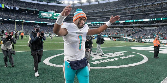 Miami Dolphins quarterback Tua Tagovailoa celebrates as he leaves the field after an NFL football game against the New York Jets, Sunday, Nov. 21, 2021, in East Rutherford, N.J.