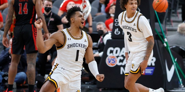 Shockers Tyson Etienne (1) and Craig Porter Jr. react after the team's 74-73 victory over the Rebels at T-Mobile Arena on Nov. 21, 2021, in Las Vegas, Nevada.