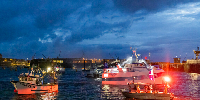 French fishing boats block the entrance to the port of Saint-Malo, western France, Friday, Nov. 26, 2021. French fishing crews are threatening to block French ports and traffic under the English Channel on Friday to disrupt the flow of goods to the U.K., in a dispute over post-Brexit fishing licenses.