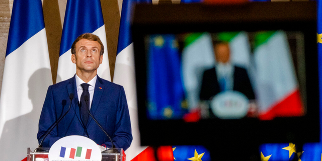 French President Emmanuel Macron, left, listens to Italian Premier Mario Draghi during a joint press conference at Villa Madama in Rome, Friday, Nov. 26, 2021, after signing the Quirinale Treaty between Italy and France, which aims to provide a stable and formalized framework for cooperation in relations between the two countries.