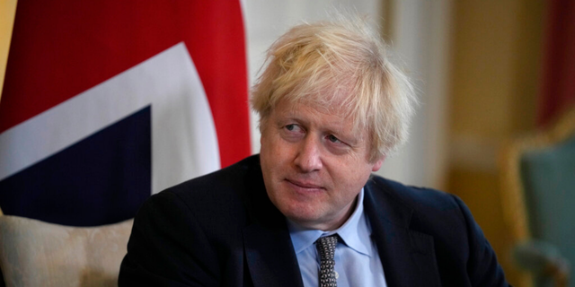 British Prime Minister Boris Johnson listens to Polish Prime Minister Mateusz Morawiecki at the start of their meeting inside 10 Downing Street, in London, Friday, Nov. 26, 2021
