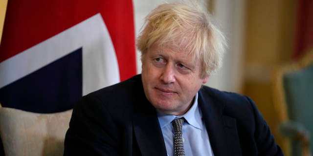 British Prime Minister Boris Johnson listens to Polish Prime Minister Mateusz Morawiecki at the start of their meeting inside 10 Downing Street, in London, Friday, Nov. 26, 2021