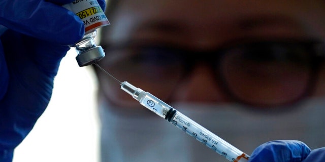 Lurie Children's hospital registered nurse Carolyn Ruyle prepares a dose of a Pfizer COVID-19 vaccine at Lurie Children's hospital Friday, Nov. 5, 2021, in Chicago. (AP Photo/Nam Y. Huh) 