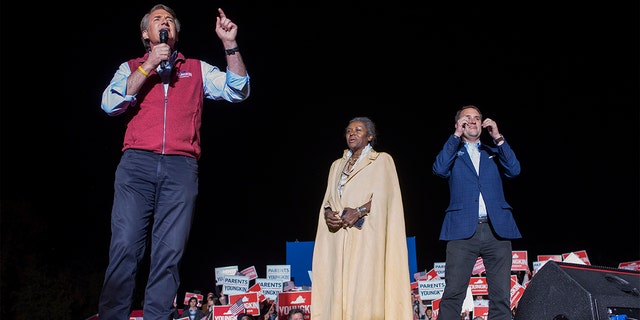 Victorious candidates Winsome Sears and Jason Miyares joined Glenn Youngkin on stage at a rally Nov. 1, 2021.