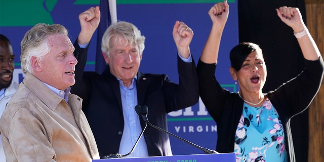 Former Democratic gubernatorial candidate, former Governor Terry McAuliffe, left, addresses supporters as Attorney General Mark Herring, center, and Lt. Gov. candidate Hala Ayala, right, applaud as of a rally as running mates, in Richmond, Va., Monday, November 1, 2021 (AP Photo / Steve Helber)