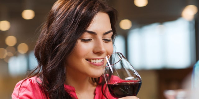 A woman drinking a glass of wine