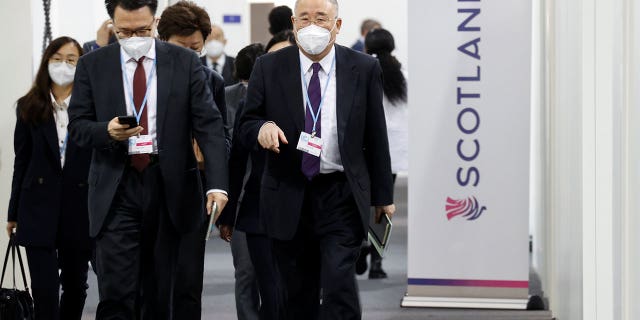 China's chief climate negotiator Xie Zhenhua walks as he attends the UN Climate Change Conference (COP26), in Glasgow, Scotland, Britain November 12, 2021.
