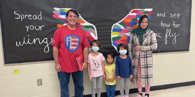 Johnny and his family inside Rea View Elementary.