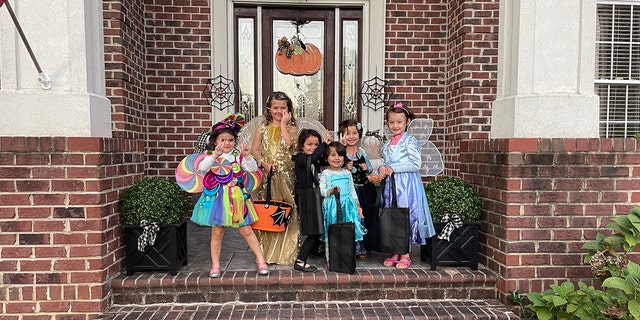 Muzhdah, Muzhgan, and Asra trick-or-treating with their new American friends.