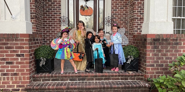 Muzhdah, Muzhgan, and Asra trick-or-treating with their new American friends.