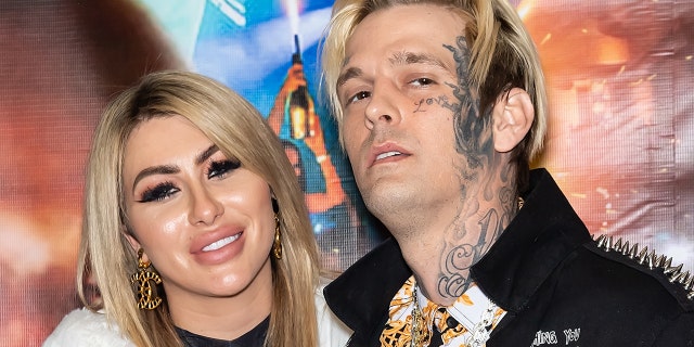 Aaron Carter (R) photographed in April with multiple face tattoos.