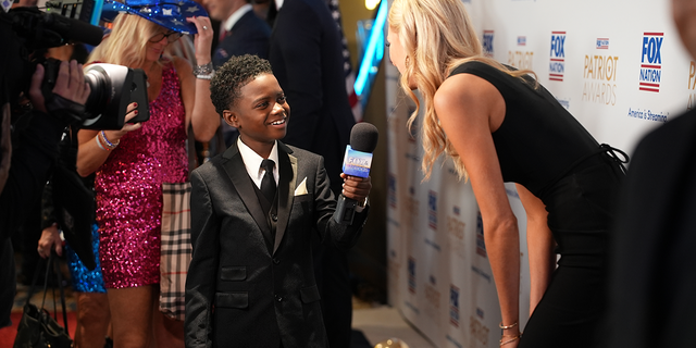 Abby Hornacek gets interviewed on the Fox Nation carpet at the Patriot Awards
