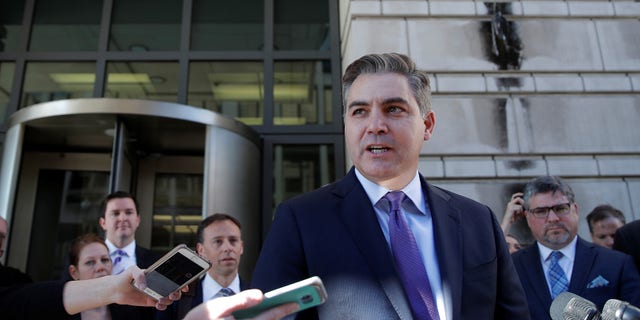 CNN chief White House correspondent Jim Acosta talks to reporters after a judge temporarily restored his White House press credentials on Nov. 16, 2018.