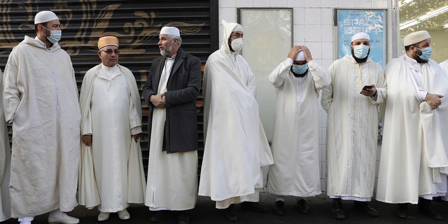 Imams from the Paris mosque gather before paying their homage to the victims of the Nov. 2015 attacks near the Bataclan concert hall in Paris on Friday, the eve of the sixth anniversary of the attacks. 