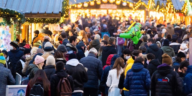 People visit the newly opened "Christkindlmarkt" Vienna's classic Christmas Market, on the square in front of the City Hall in Vienna, Austria, on November 12, 2021, during the ongoing coronavirus (Covid-19) pandemic. - Austrian Chancellor Alexander Schallenberg said on November 12, 2021 he wanted to introduce a nationwide lockdown for those not vaccinated or recovered from coronavirus, as the country struggles with rapidly rising cases. - Austria OUT (Photo by GEORG HOCHMUTH / APA / AFP) / Austria OUT (Photo by GEORG HOCHMUTH/APA/AFP via Getty Images)