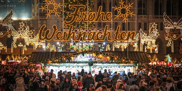People crowd a Christmas market in Vienna, Austria, Sunday, Nov. 21, 2021. 