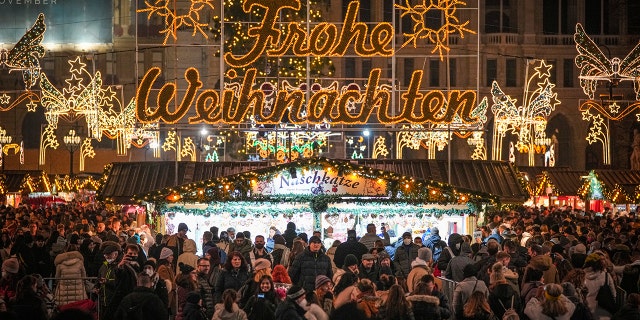 People crowd a Christmas market in Vienna, Austria, Sunday, Nov. 21, 2021. 