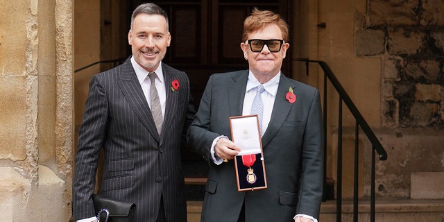 Sir Elton John with his partner David Furnish, after being made a member of the Order of the Companions of Honour for services to music and to charity during an investiture ceremony at Windsor Castle, in Windsor, England, on Nov. 10, 2021.