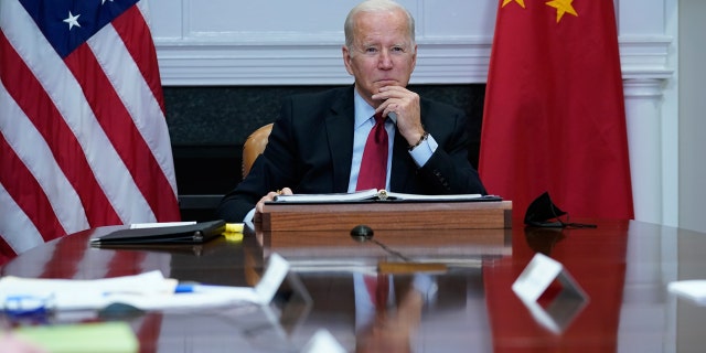 President Biden listens as he meets virtually with Chinese President Xi Jinping at the White House on Monday, Nov. 15, 2021.