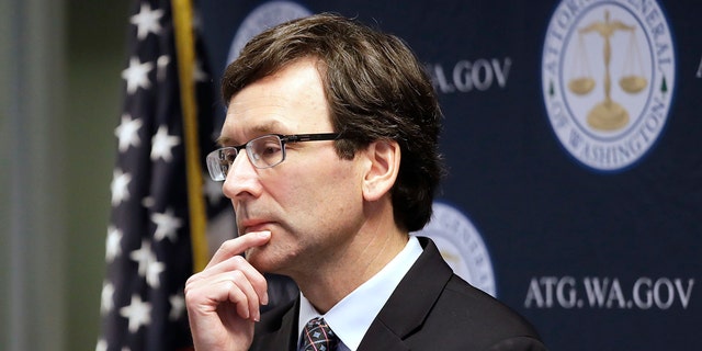 Washington state Attorney General Bob Ferguson looks on during a news conference in Seattle on Dec. 17, 2019. A report from Ferguson's office directs legislators to create a "public health approach" to dealing with domestic violent extremism.