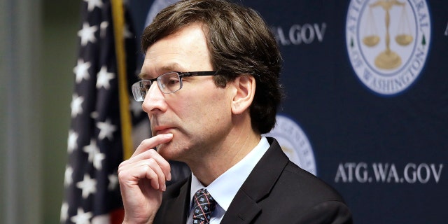 Washington state Attorney General Bob Ferguson looks on during a news conference in Seattle on Dec. 17, 2019. A report from Ferguson's office directs legislators to create a "public health approach" to dealing with domestic violent extremism.