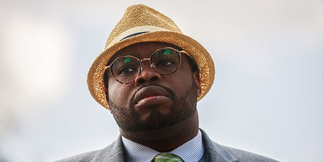 Vauhxx Booker listens during a press conference after a special prosecutor charged him with felony assault and trespassing over a year after he was attacked in July 2020 at Lake Monroe, at the Monroe County Courthouse in Bloomington, Indiana.