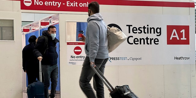 Passengers get a COVID-19 test at Heathrow Airport in London on Monday, Nov. 29, 2021. 