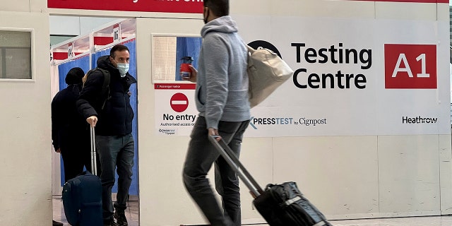 Passengers get a COVID-19 test at Heathrow Airport in London on Monday, Nov. 29, 2021.