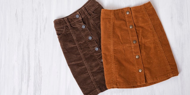 Two brown skirts on a wooden background. Fashion concept