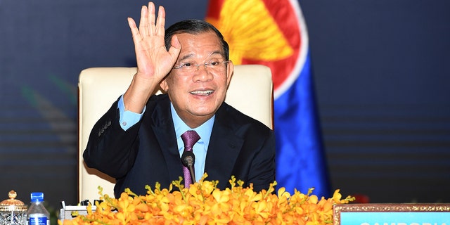 In this photo provided by An Khoun Sam Aun/National Television of Cambodia, Cambodian Prime Minister Hun Sen gestures as he joins an online meeting of the ASEAN-China special summit at Peace Palace in Phnom Penh, Cambodia, Monday, Nov. 22, 2021. 