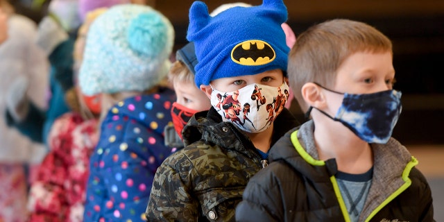 Students at Immanuel Unite Church of Christ line up to go outside after helping to sort donated food items. Recently, a state court tossed a mask mandate for Pennsylvania schools.
