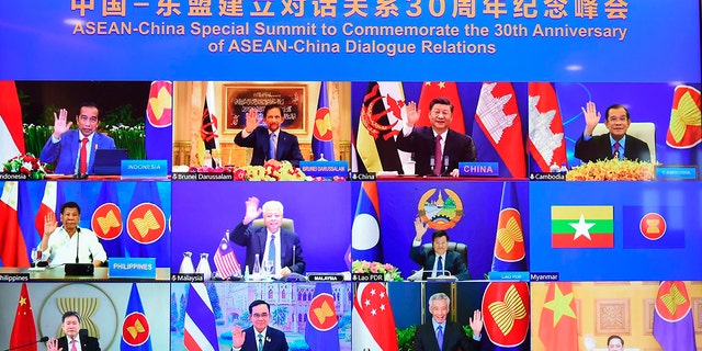 This image provided by the Malaysian Prime Minister's Office shows ASEAN leaders and Chinese President Xi Jinping, second from top right, on screen during an online meeting of the ASEAN-China Special Summit in Kuala Lumpur, Malaysia, Monday 22 November 2021. 