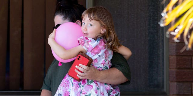 Cleo Smith, right, and her mother, Ellie Smith, leave a house where they spent the night after 4-year-old Cleo was rescued in Carnarvon, Australia, Thursday, Nov. 4, 2021.