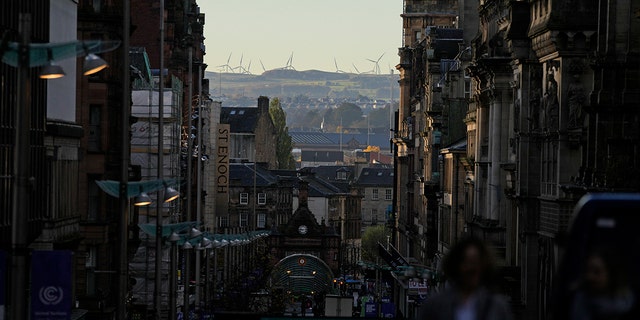 A wind farm can be seen in the distance at the COP26 U.N. Climate Summit in Glasgow, Scotland, on Wednesday, Nov. 3, 2021.