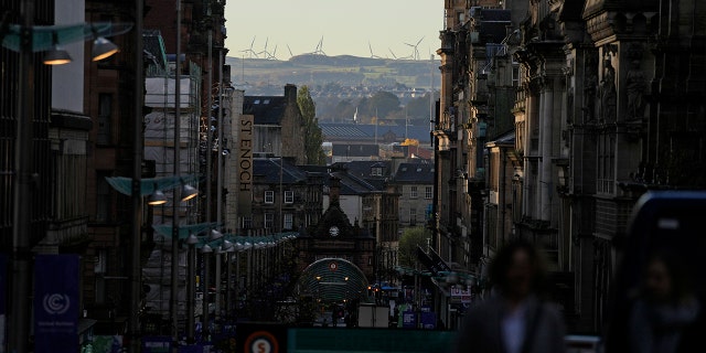 A wind farm can be seen in the distance at the COP26 U.N. Climate Summit in Glasgow, Scotland, on Wednesday, Nov. 3, 2021.