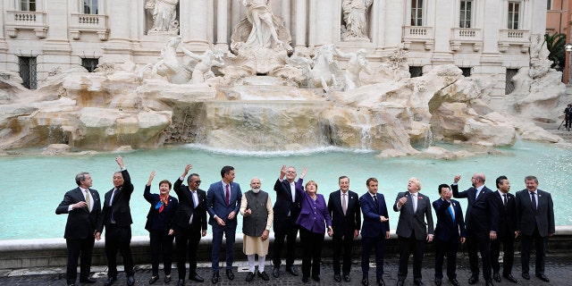 Leaders of the G20 pose in front of the during Trevi Fountain during an event for the G20 summit in Rome on Oct. 31, 2021.