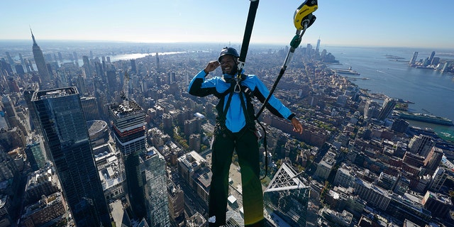 Climb guide Jason Johnson leans off the edge at the top of City Climb, a new attraction at 30 Hudson Yards in New York on Nov. 3.