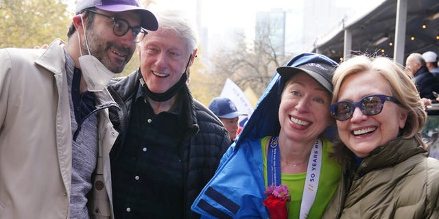 Athletics - TCS New York City Marathon - New York, United States - November 7, 2021 Chelsea Clinton reacts after finishing the marathon with husband Marc Mezvinsky , mother Former United States Secretary of State Hillary Clinton and father Former United States President Bill Clinton REUTERS/Carlo Allegri