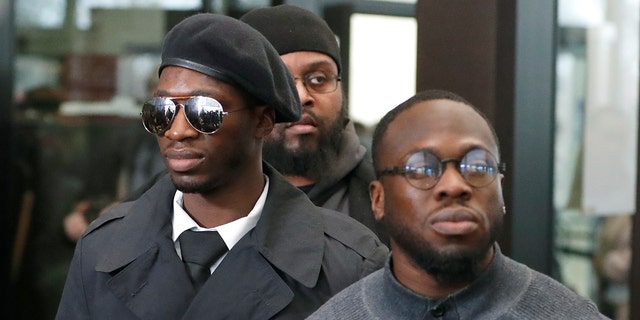 Brothers Olabinjo Osundairo, right, and Abimbola Osundairo, appear outside the Leighton Criminal Courthouse in Chicago, Feb. 24, 2020.