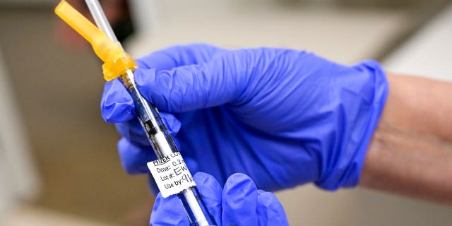 Nurse Mary Ezzat prepares to administer a Pfizer COVID-19 booster shot to Jessica M., Thursday, Aug. 19, 2021, at UCI Medical Center in Orange, California.